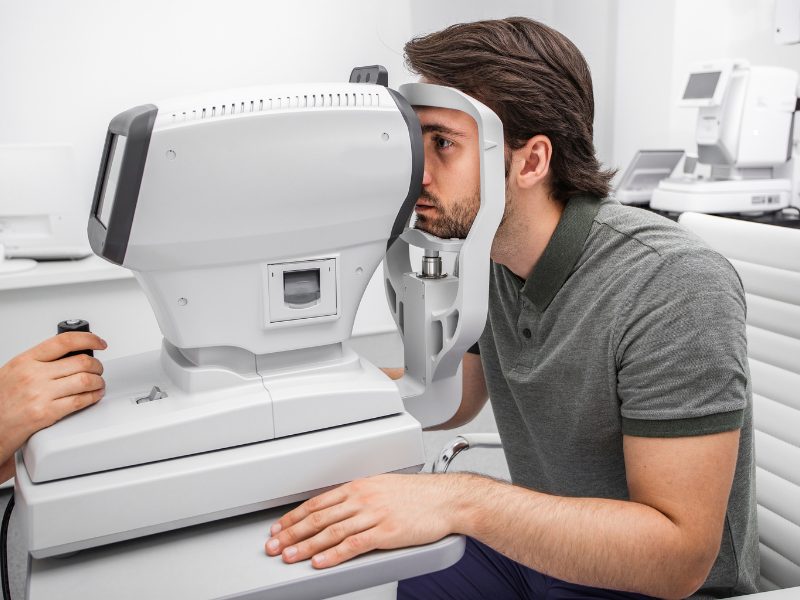 Ophthalmologist performing laser treatment using slit lamp system in an ophthalmic clinic